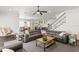 Open-concept living room with staircase, connected to a dining area and modern kitchen at 5024 W Homer Ave, Tampa, FL 33629