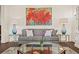 Well-appointed living room featuring a plush sofa, glass-topped tables, and a stylish area rug at 5024 W Homer Ave, Tampa, FL 33629