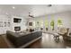 Spacious living room with fireplace, built-ins, and doors leading to an outdoor balcony, offering a bright and open space at 5024 W Homer Ave, Tampa, FL 33629