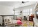 Bright loft space featuring a chaise lounge, desk, and colorful floral rug at 5024 W Homer Ave, Tampa, FL 33629