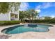 Beautiful backyard pool and spa, surrounded by a stone patio and manicured landscaping at 5024 W Homer Ave, Tampa, FL 33629