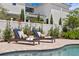 Chic pool deck featuring stylish lounge chairs and lush greenery, perfect for sunny relaxation at 5024 W Homer Ave, Tampa, FL 33629