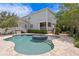 Backyard showcasing a pool, jacuzzi, manicured lawn and garden with a multi-story home's exterior in the background at 5024 W Homer Ave, Tampa, FL 33629