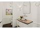 Stylish powder room featuring wainscoting, a unique vanity with a vessel sink, and modern fixtures at 5024 W Homer Ave, Tampa, FL 33629