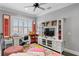 Bright upstairs hallway with media center, desk, and colorful rug at 5024 W Homer Ave, Tampa, FL 33629