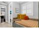 Bright window seat with shuttered window, colorful pillows, and striped cushion adding charm to this bathroom at 5024 W Homer Ave, Tampa, FL 33629