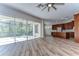 Open floor plan with wood floors connecting living room, kitchen and screened patio at 5224 Fairway One Dr, Valrico, FL 33596