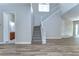 Open concept living area with wood floors, staircase, and neutral walls at 5224 Fairway One Dr, Valrico, FL 33596