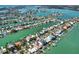 Aerial view of a waterfront home with multiple docks in a vibrant neighborhood surrounded by canals and waterways at 535 Johns Pass Ave, Madeira Beach, FL 33708