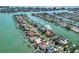 Stunning aerial view showcasing a waterfront property with private docks nestled among picturesque canals and beautiful homes at 535 Johns Pass Ave, Madeira Beach, FL 33708