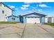 Lovely blue home with white trim, an attached garage, and well-kept landscaping enhancing curb appeal at 535 Johns Pass Ave, Madeira Beach, FL 33708