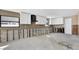 Kitchen featuring white cabinets, a black range hood, and gray tile backsplash, awaiting completion at 535 Johns Pass Ave, Madeira Beach, FL 33708