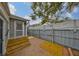 Private backyard with tile patio, wood steps and an outdoor shower with a privacy fence at 5601 2Nd N Ave, St Petersburg, FL 33710