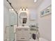 Modern bathroom featuring a glass-enclosed shower, vanity, and decorative mirror at 5601 2Nd N Ave, St Petersburg, FL 33710