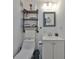 Cozy bathroom featuring open shelving, a decorative mirror and a white sink with white cabinetry at 5601 2Nd N Ave, St Petersburg, FL 33710