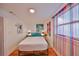 Bedroom with wood floors and bright decorative colorful curtain at 5601 2Nd N Ave, St Petersburg, FL 33710
