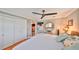 Bright bedroom featuring a ceiling fan, closet and an ornate mirror above a wooden bedside table at 5601 2Nd N Ave, St Petersburg, FL 33710