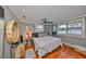 Cozy bedroom with wood floors, a ceiling fan, and natural light from windows at 5601 2Nd N Ave, St Petersburg, FL 33710