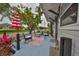 Charming front porch featuring blue outdoor furniture, an umbrella and a shade tree at 5601 2Nd N Ave, St Petersburg, FL 33710