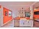 Bright, open kitchen showcasing a large island with sink, white cabinetry, and adjacent living area at 5601 2Nd N Ave, St Petersburg, FL 33710