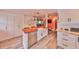 Open kitchen featuring a large island with sink, modern appliances, and stylish white cabinetry at 5601 2Nd N Ave, St Petersburg, FL 33710