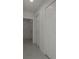 Hallway area with white doors and sleek tile flooring at 6125 Liberty Ave, Temple Terrace, FL 33617