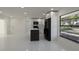 Modern kitchen featuring sleek white cabinets, black appliances, and a stylish kitchen island at 6125 Liberty Ave, Temple Terrace, FL 33617