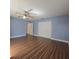 Bedroom with a ceiling fan, wood-look flooring, and a double closet at 6194 59Th N Pl, St Petersburg, FL 33709