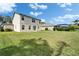 Expansive backyard with lush green grass and a view of the home's rear exterior at 6308 Bridgevista Dr, Lithia, FL 33547