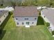 Aerial shot of a home's backyard featuring a spacious lawn with access through sliding glass doors at 6308 Bridgevista Dr, Lithia, FL 33547