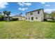 Spacious backyard with lush green grass and a view of the home's rear exterior at 6308 Bridgevista Dr, Lithia, FL 33547