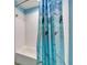 Bathroom with a dolphin-themed shower curtain and a white tiled shower/tub at 6308 Bridgevista Dr, Lithia, FL 33547