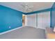 This bedroom features blue walls, a ceiling fan, and a closet at 6308 Bridgevista Dr, Lithia, FL 33547
