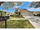 Charming two-story home featuring a spacious three car garage and a manicured lawn at 6308 Bridgevista Dr, Lithia, FL 33547