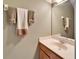 This half bathroom features a single sink vanity, a mirror and decorative towels at 6308 Bridgevista Dr, Lithia, FL 33547