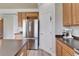 Well-appointed kitchen features stainless steel appliances, wood cabinets, and island at 6308 Bridgevista Dr, Lithia, FL 33547