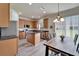 Modern kitchen with stainless appliances and adjoining dining area with sliding glass doors at 6308 Bridgevista Dr, Lithia, FL 33547