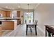 Inviting kitchen area featuring wood floors, an island, and a dining table at 6308 Bridgevista Dr, Lithia, FL 33547