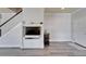Bright living room with gray floors, a built-in entertainment center, and a staircase at 6308 Bridgevista Dr, Lithia, FL 33547