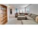 Inviting living room with a plush sectional sofa, bright windows, neutral carpet, and built-in bookshelves at 6308 Bridgevista Dr, Lithia, FL 33547