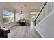 Bright living room shows open concept with wood floors, staircase, and view into the adjacent dining area at 6308 Bridgevista Dr, Lithia, FL 33547