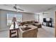 Bright and airy living room with neutral carpet, ceiling fan, large windows, and a comfortable sectional sofa at 6308 Bridgevista Dr, Lithia, FL 33547