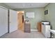 This office features green walls, a closet, a white board, and cabinets at 6308 Bridgevista Dr, Lithia, FL 33547