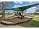 Community playground with slides and climbing features set against a backdrop of a lake at 6308 Bridgevista Dr, Lithia, FL 33547