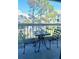 Cozy outdoor balcony setup with a tea set, offering a pleasant neighborhood view at 6826 Stones Throw N Cir # 11305, St Petersburg, FL 33710