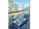 Balcony featuring outdoor seating with a tea set, overlooking landscaped grounds and residential buildings at 6826 Stones Throw N Cir # 11305, St Petersburg, FL 33710