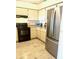 Well-lit kitchen featuring modern stainless steel appliances and ample cabinet space at 6826 Stones Throw N Cir # 11305, St Petersburg, FL 33710