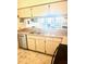 Functional kitchen with double sink, stainless steel appliances, and granite countertops at 6826 Stones Throw N Cir # 11305, St Petersburg, FL 33710