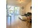 Bright living room featuring a balcony, hardwood floors, a leather sofa and ottoman seating at 6826 Stones Throw N Cir # 11305, St Petersburg, FL 33710