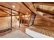 Attic area with wooden beams, skylight, and carpet at 701 S Edison Ave, Tampa, FL 33606